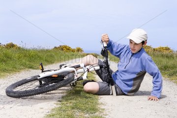 Boy falling from a bike on a countryside path