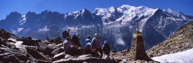 Cairn and hikers face of Mont Blanc massif Alps France