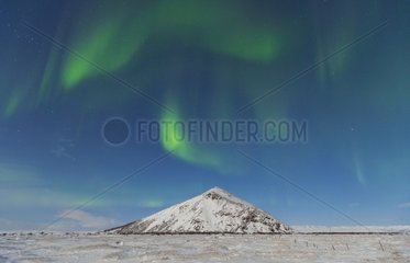 Northern lights over a snowy landscape Iceland