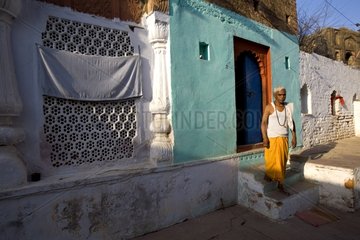 Old Man leaving his colored house Uttar Pradesh India