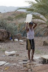 Boy washing Qaryah Village on the island of Socotra