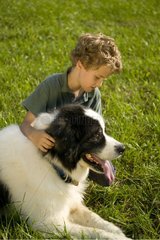 Seven years old child cherishing a large dog Pennsylvania