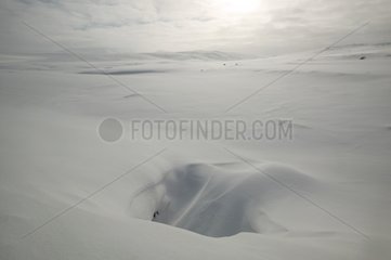 Hole in snow covering a plateau in Islande