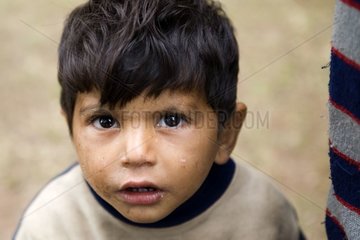 Young Gypsy boy portrait in a camp Bulgaria