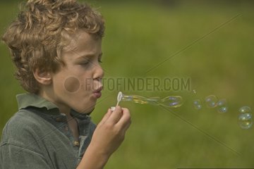 Portrait of a boy blowing bubbles Pennsylvannia USA