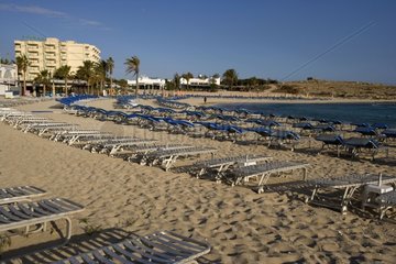 Deckchairs and parasols on a tourist beach Cyprus