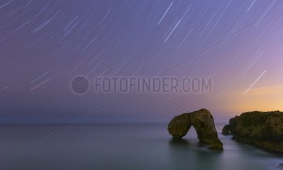 Natural arch on the Cantabrian sea by night Asturias Spain