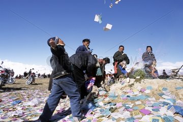 Tibetan young boy throwing prayer papers Kham area