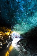 Tourist in an ice cave in the Skaftafell NP in Iceland