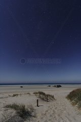 Starry sky above a moonlit beach France