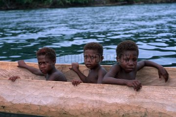Boys with trigger boat Witu Islands Bismark Archipelago
