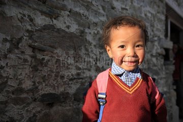 Smiling child returning from school in the village of Karcha