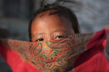 Portrait of a girl playing with a scarf India