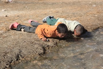 Children drinking Creek Village Pidmo India