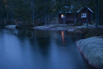 Cabin on a lake at dusk Skuleskogen Sweden