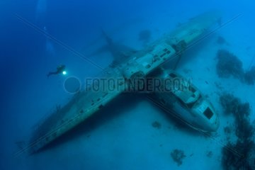 Scuba diver and Wreck of Catalina airplane Tahiti Polynesia