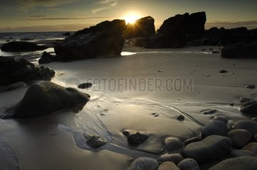 Sunset on a creek at low tide Brittany France