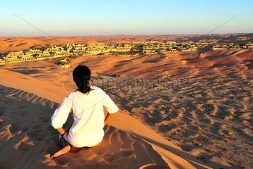 Woman in front of a hotel in the Rub al-Khali desert Abu Dhabi