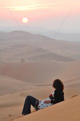 Woman resting in the desert of Rub al-Khali Abu Dhabi