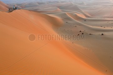 Tourists on a sand dune desert of Rub al-Khali Abu Dhabi