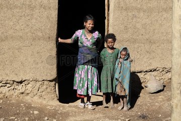 Woman and children to a traditional house Ethiopia