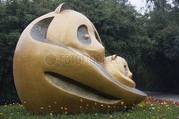 Golden statue of a Giant panda in front of research center