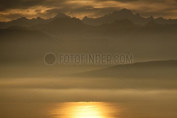 Sunrise on the Geneva lake in misty atmosphere