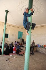 Children playing up to a column Chak Chak in Iran