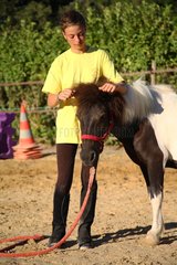 Girl doing exercise with a foal France
