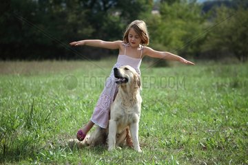 Girl playing with a Golden Retriever Provence France