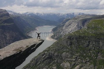Trolltunga rock overlooking the empty 600 m in Norway