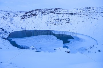 Crater lake of the Kerid volcano in winter in Iceland