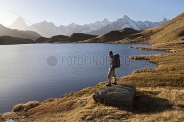 Walker near a mountain lake Alps Valais Switzerland