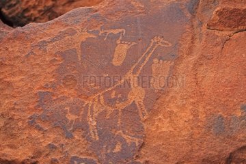 Petroglyph Site Giraffes and human feet Peet Alberts Namibia
