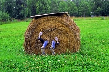 Couple in a straw stack in Alaska