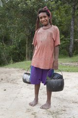 Girl returning from a source Papua New Guinea