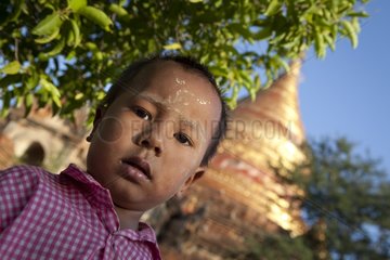 Boy in front of a pagoda in Bagan in Burma