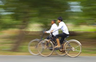 Boys bicycling at Angkor Thom in Cambodgia