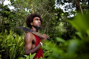 Young man Kanak and machete in the forest New Caledonia