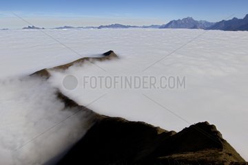 Peak above a sea of fog Valais Alps Switzerland