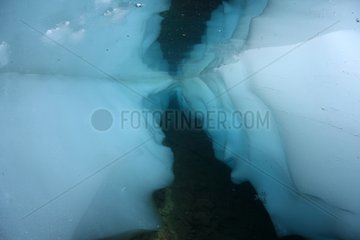Ice diving in a mountain lake during thawing France