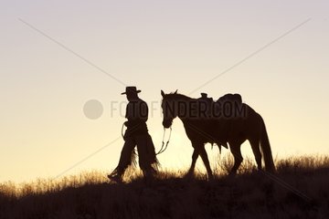 Cowboy at sunset The Hideout Guest Ranch Wyoming USA