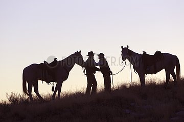 Cowboys at sunset The Hideout Guest Ranch Wyoming USA