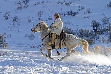 Cowboy in the snow The Hideout Guest Ranch Wyoming USA