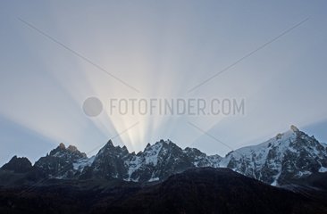 Sun rays behind the Aiguilles de Chamonix Alps