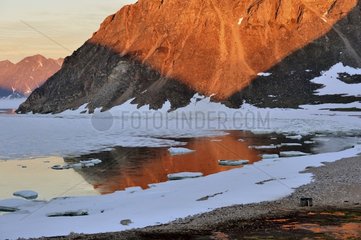 Reflection hills and ice at midnight Cap Greg Greenland