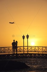 Couple on a bridge at sunset Aruba Dutch Caribbean