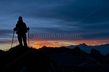 Silouette of Hiker at sunrise Valais Alps Switzerland
