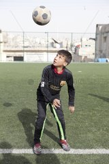 Palestinian boy playing soccer Jordan