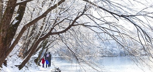 People on lakeside in winter Plitvice lakes NP Croatia